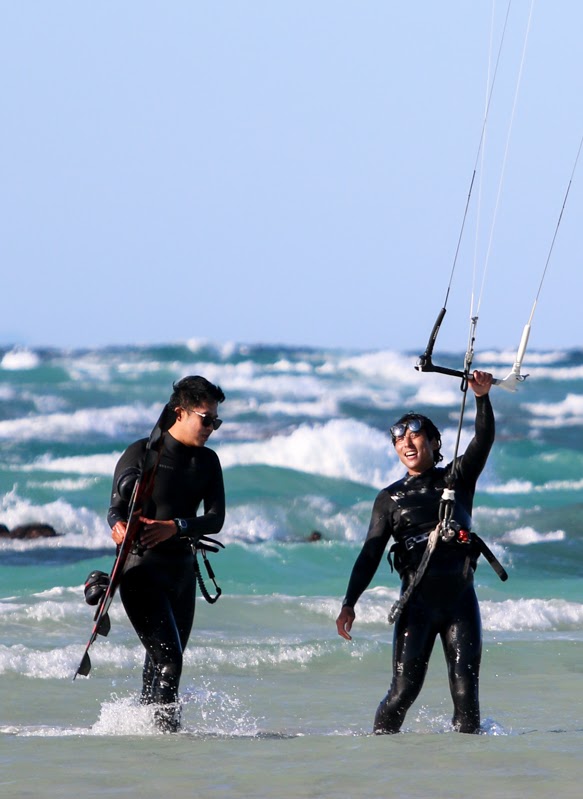 Jeju kitesurfing instructor together with student at the vibrant blue gimnyeong sea, during a kitesurf lesson, Teaching Kitesurfing in Jeju Island South Korea. Using Jeju Kite lab rental gear.