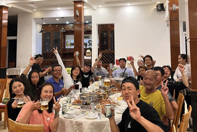 staff and members of the Vietnam winter camp, having dinner