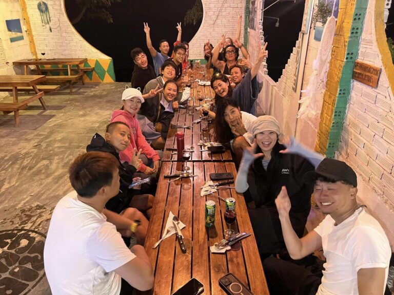 staff and members of the Vietnam winter camp, having dinner