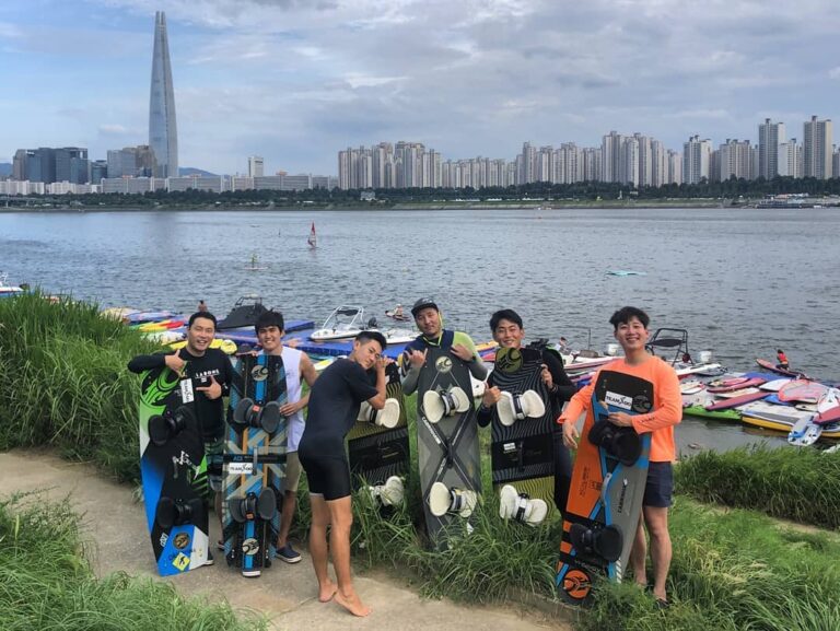 Members of Hi-Wind standing in front of the Han river in the middle of Seoul with their Kitesurfing gear. Kitesurfing team in Seoul, South Korea. Kiteboarding South Korea. One of the many fun watersports in Seoul, Korea