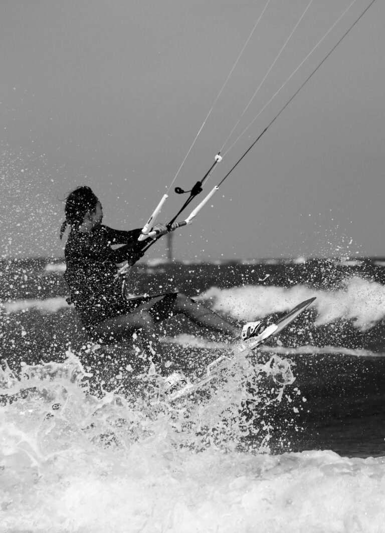 woman kitesurfing in the waves of Jeju island, South Korea. Kitesurfing Jeju Island South Korea. Woman bravely jumping over the waves on a windy day at Jeju Island