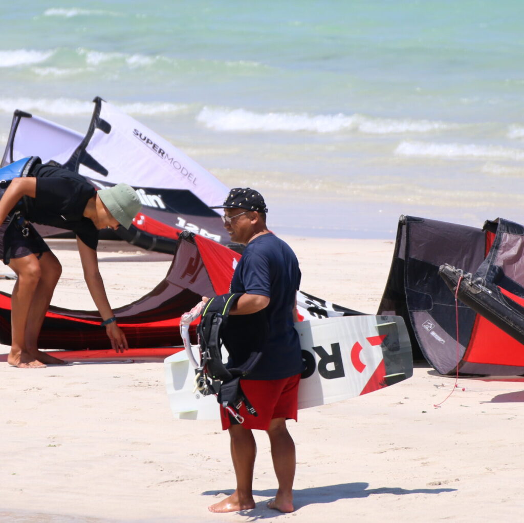 customers happy on the Jeju island beach with our wing foil and kitesurfing rental gear. Kitesurfing Jeju Island south Korea, Wing foil rental gear South Korea. Rental gear watersports jeju South Korea