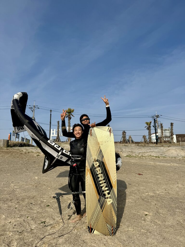 Kitesurf student with her Kitesurf instructor in Jeju Island South Korea. Sinyang Beach. Start of the season