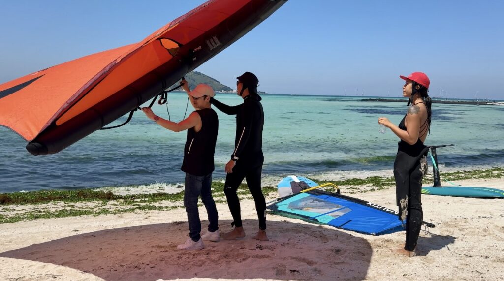 wing foil lesson west Jeju, South Korea. Ground training with students on the beach. Wing foiling, Wing foil in Jeju South Korea